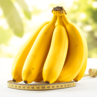 Banana Nutrition Facts: A bunch of ripe yellow bananas on a bright background, with a measuring tape and nutrition labels subtly included to highlight health an